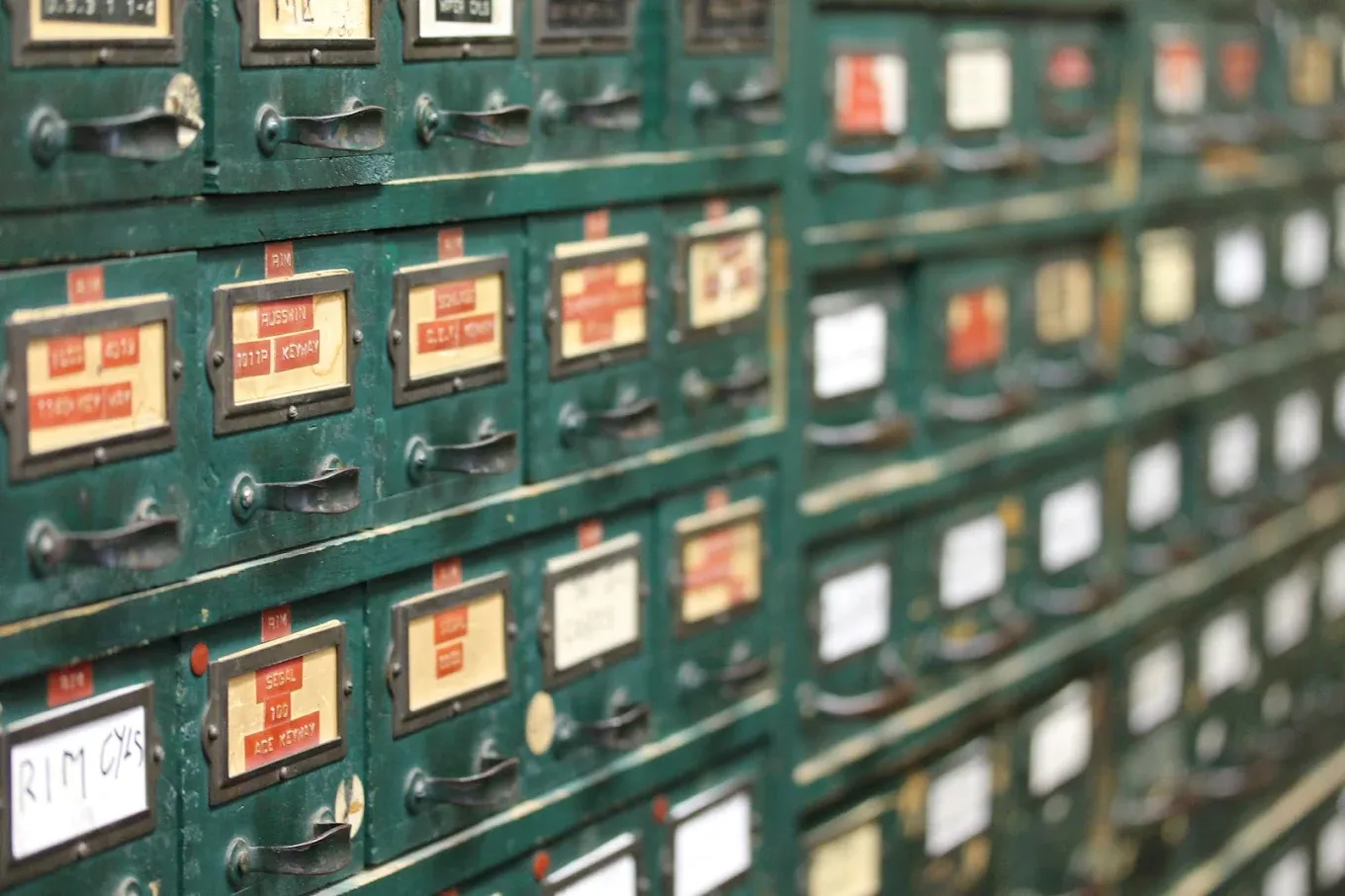 Rows of original green key blank drawers, each labeled by hand
